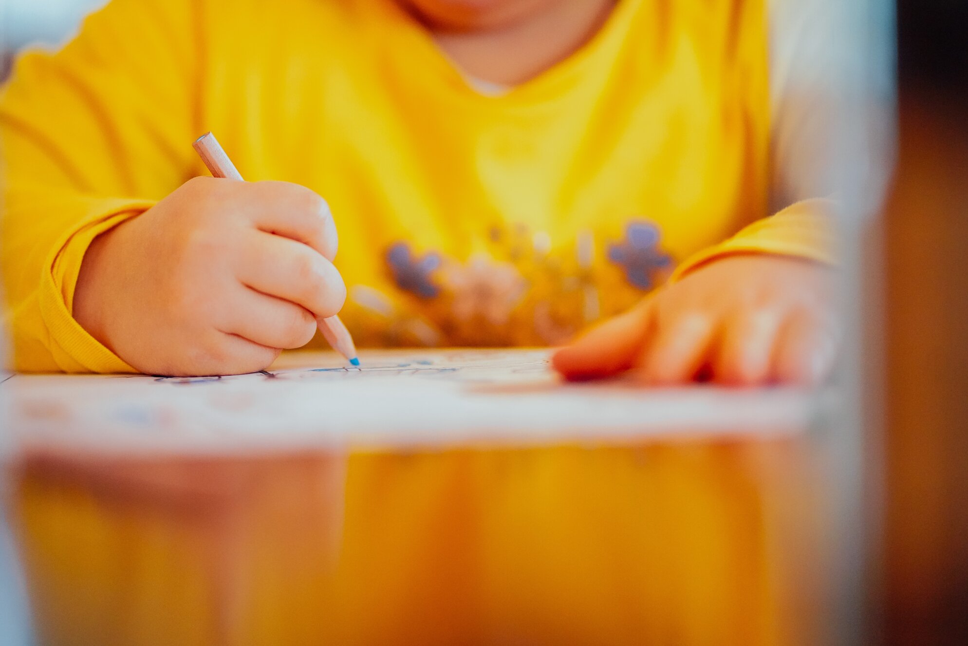 child drawing on a paper